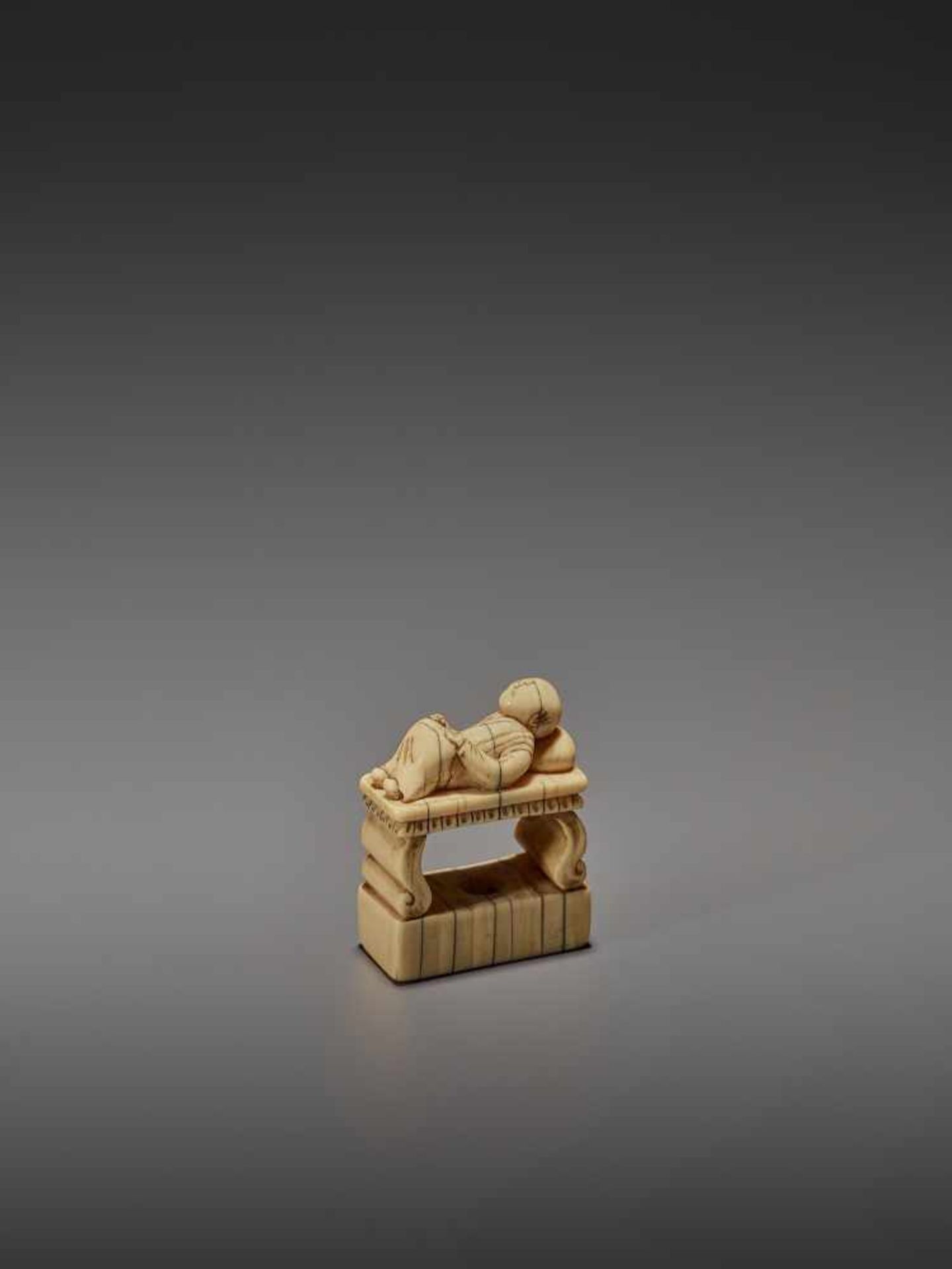 AN EARLY IVORY NETSUKE OF A CHINESE MAN SLEEPING ON AN OPIUM BED UnsignedJapan, early 18th - Image 5 of 11