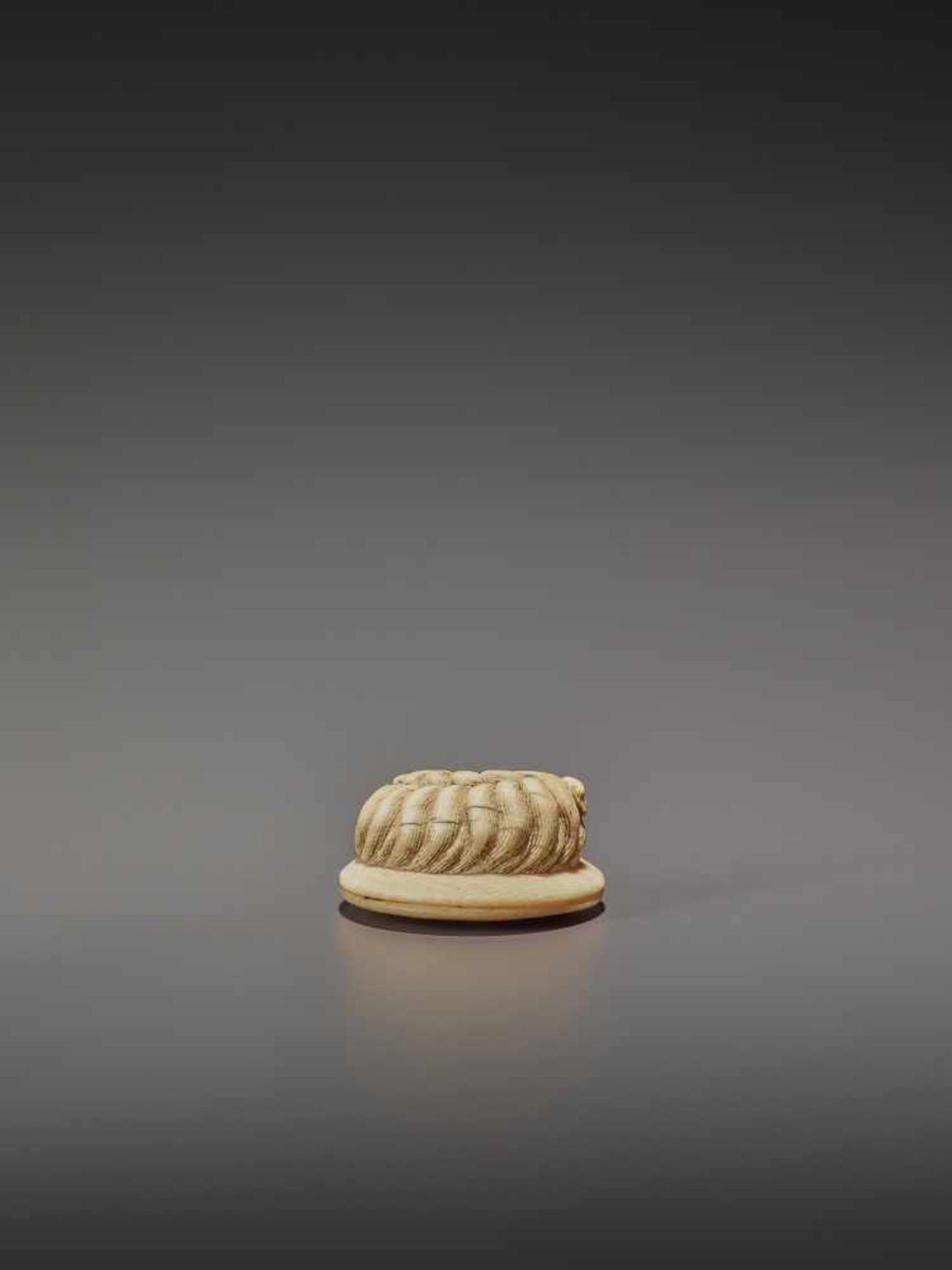 AN IVORY NETSUKE OF A SHAGGY DOG ON A ZABUTON UnsignedJapan, 19th century, Edo period (1615-1868) - Image 6 of 9