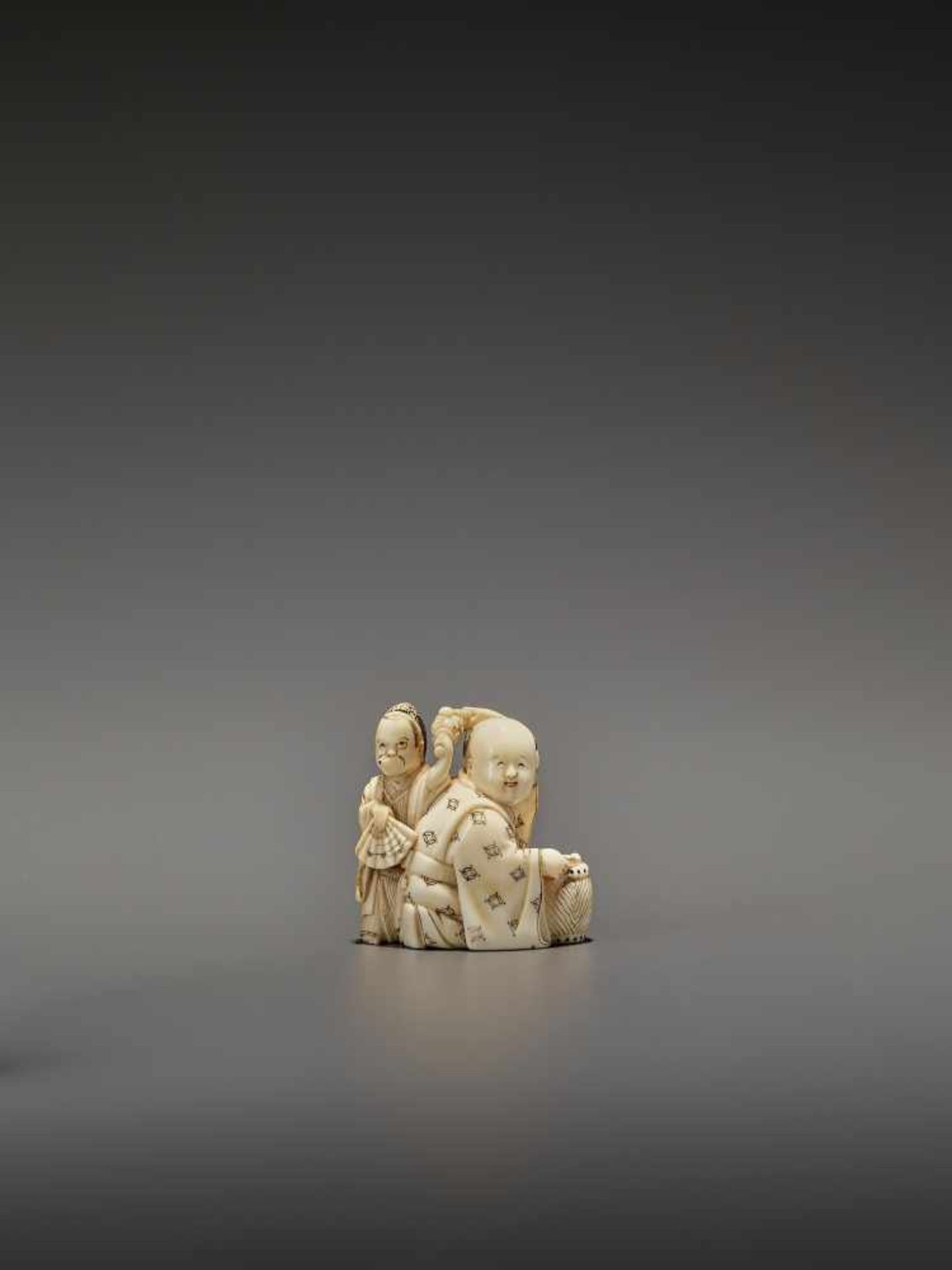 HOMIN: AN IVORY NETSUKE OF TWO BOYS AS MUSICIANS By Homin, signed Homin with kaoJapan, Edo/Tokyo,