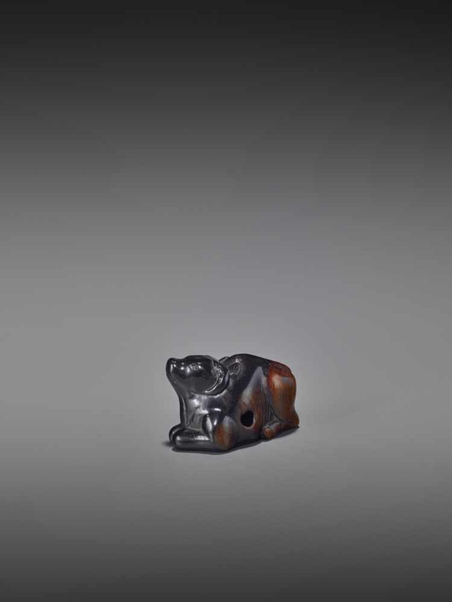 A KUROGAKI WOOD NETSUKE OF AN OX UnsignedJapan, early 18th century, Edo period (1615-1868)An early