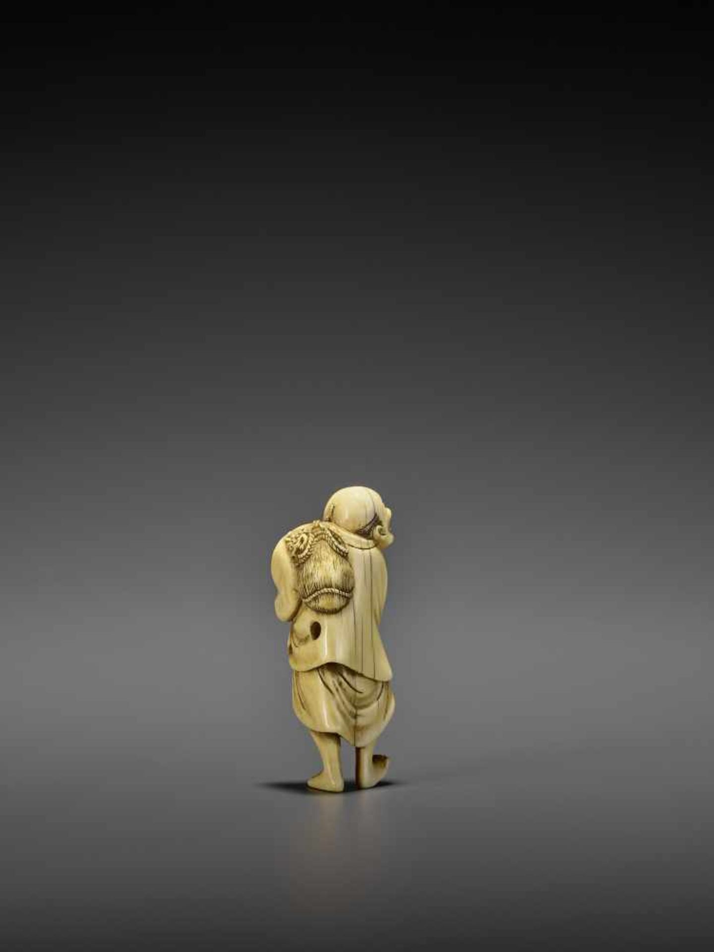 AN IVORY NETSUKE OF A PERSIMMON MERCHANT UnsignedJapan, early 19th century, Edo period (1615-1868) - Image 5 of 10