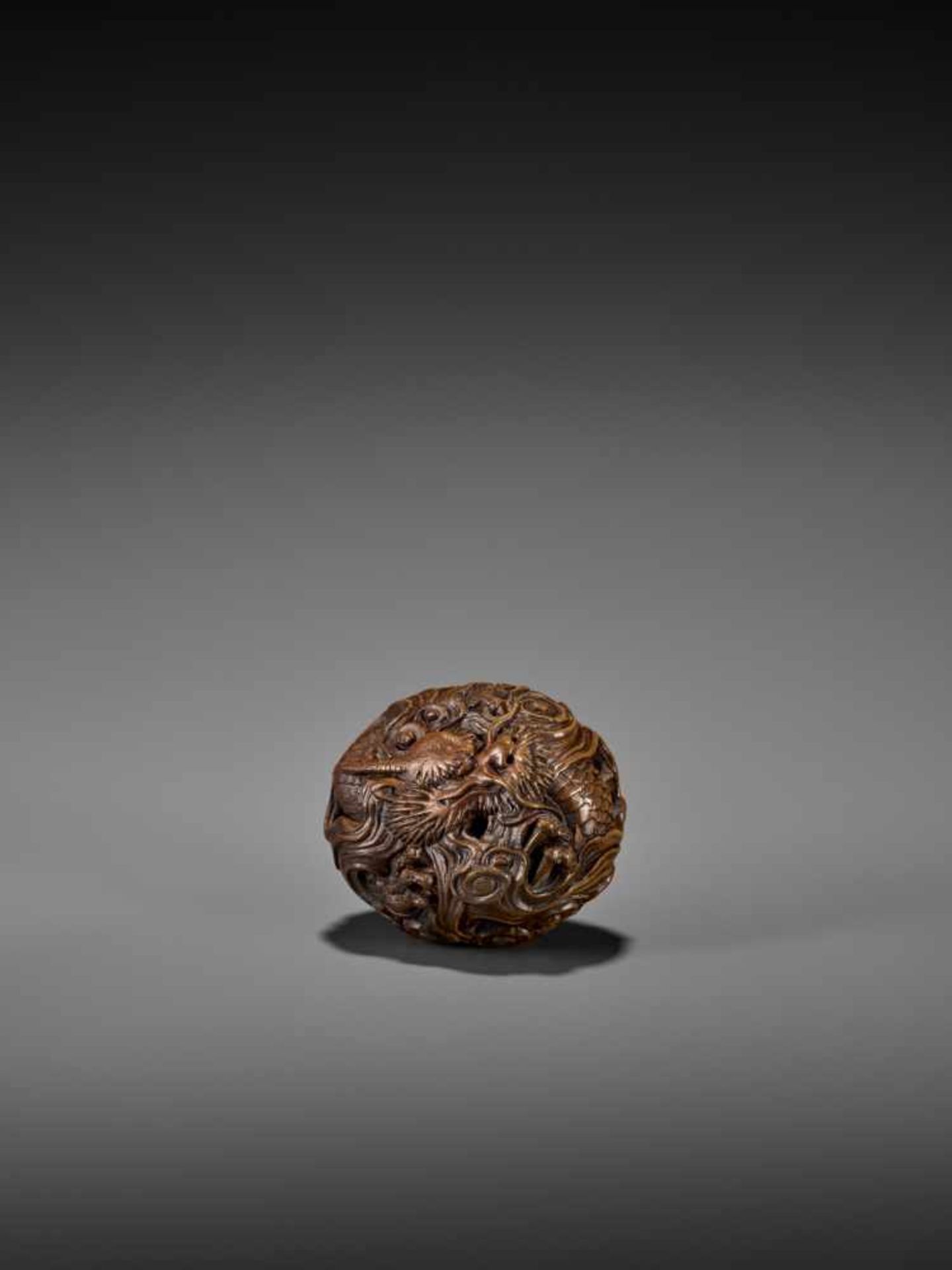 MASANAO: AN EXCELLENT WOOD MANJU NETSUKE OF A CELESTIAL DRAGON By Masanao, signed MasanaoJapan,