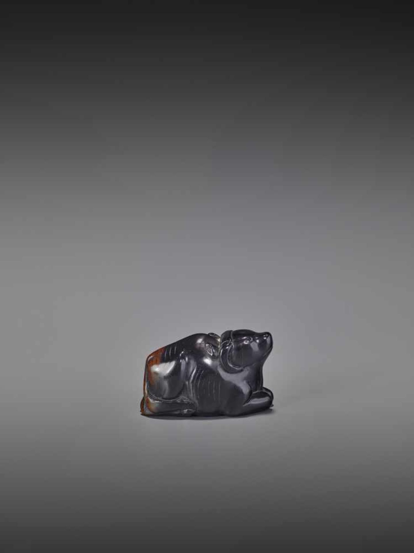 A KUROGAKI WOOD NETSUKE OF AN OX UnsignedJapan, early 18th century, Edo period (1615-1868)An early - Image 10 of 11