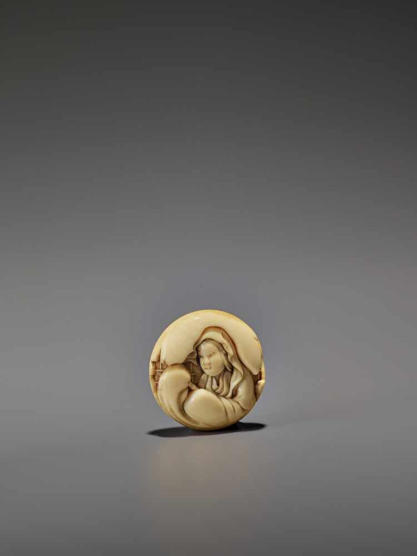 ICHIYUSAI: A MARINE IVORY MANJU NETSUKE OF ONNA DARUMA By Ichiyusai Naoharu/Naomitsu, signed