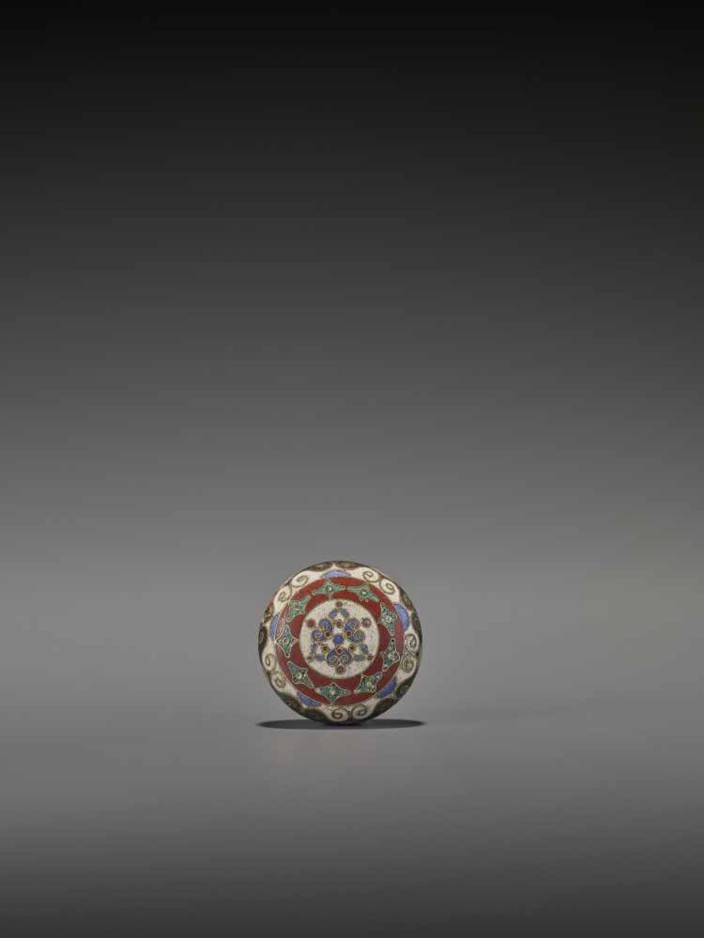 A RARE CLOISONNÉ ENAMEL MANJU NETSUKE UnsignedJapan, ca. 1860A rare cloisonné enamel netsuke in