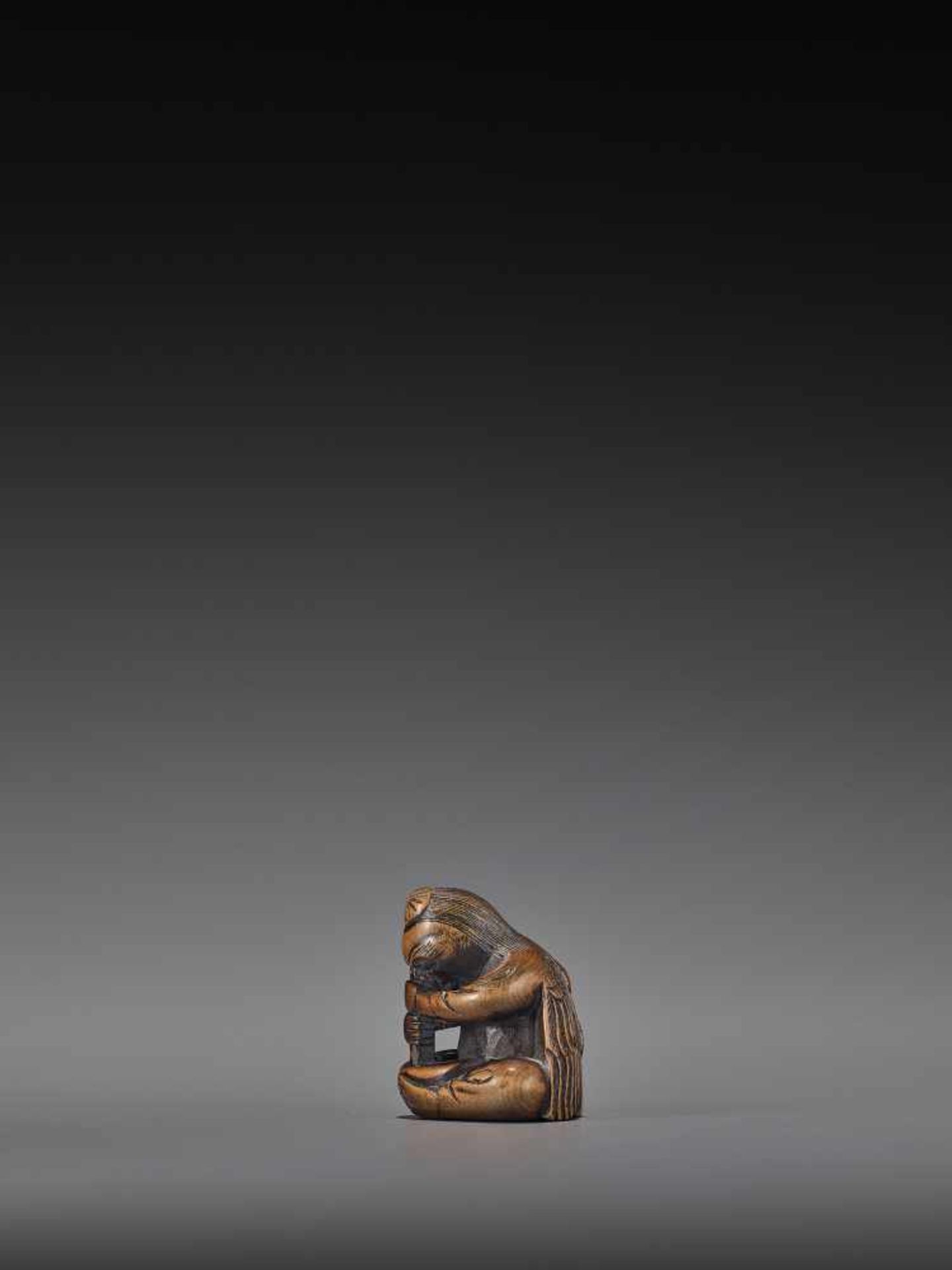 A WOOD NETSUKE OF A TENGU STIRRING MISO UnsignedJapan, 19th century, Edo period (1615-1868)A wood - Bild 5 aus 9