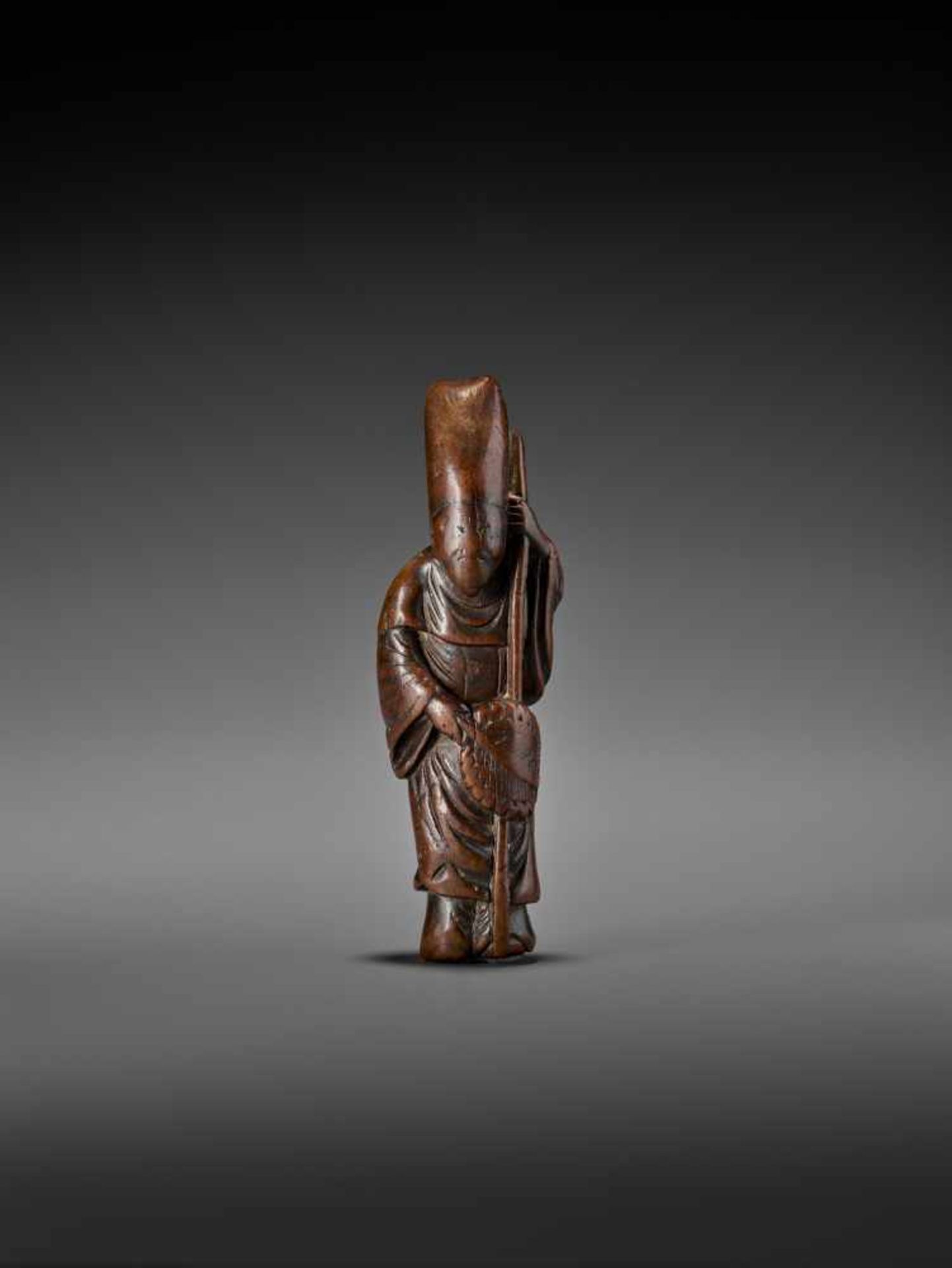 A LARGE AND EARLY WOOD NETSUKE OF A CHINESE COURT OFFICIAL UnsignedJapan, early 18th century, Edo