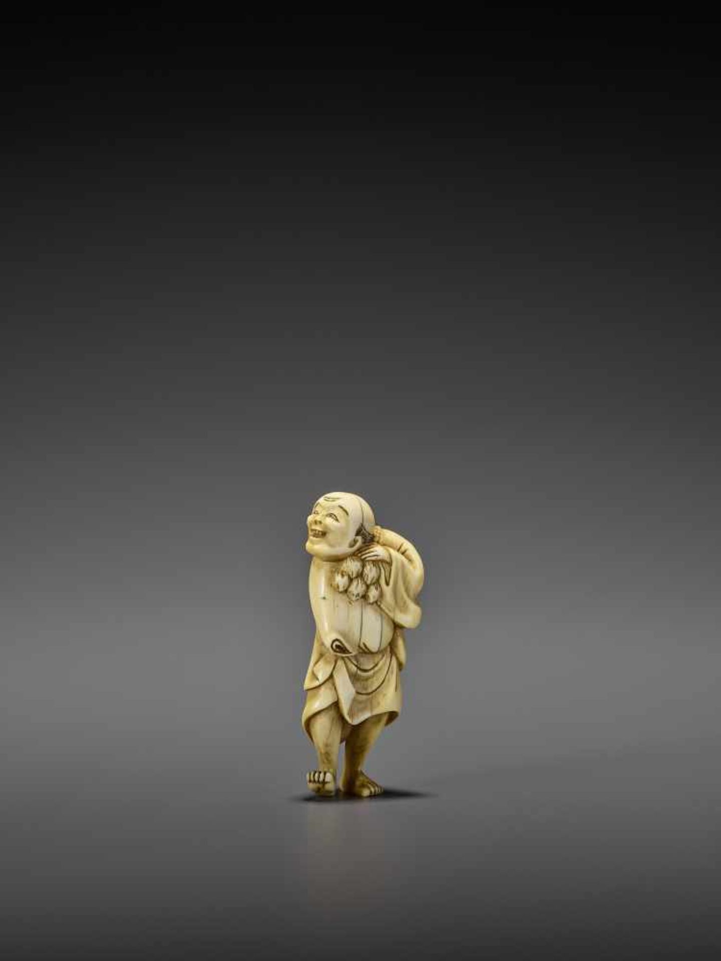 AN IVORY NETSUKE OF A PERSIMMON MERCHANT UnsignedJapan, early 19th century, Edo period (1615-1868) - Image 2 of 10