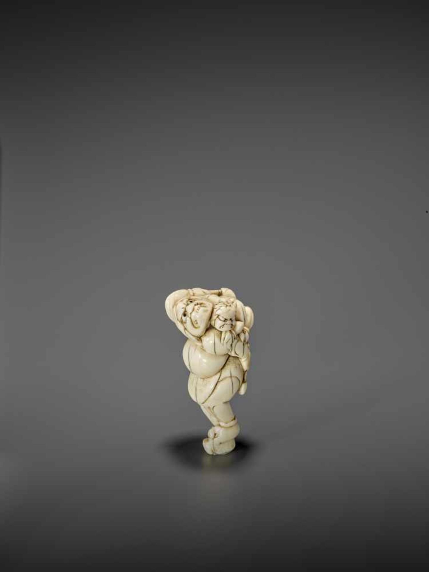 A RARE IVORY NETSUKE OF RAIJIN WITH RAITARO ARMED WITH FISH HEADS UnsignedJapan, 18th century, Edo