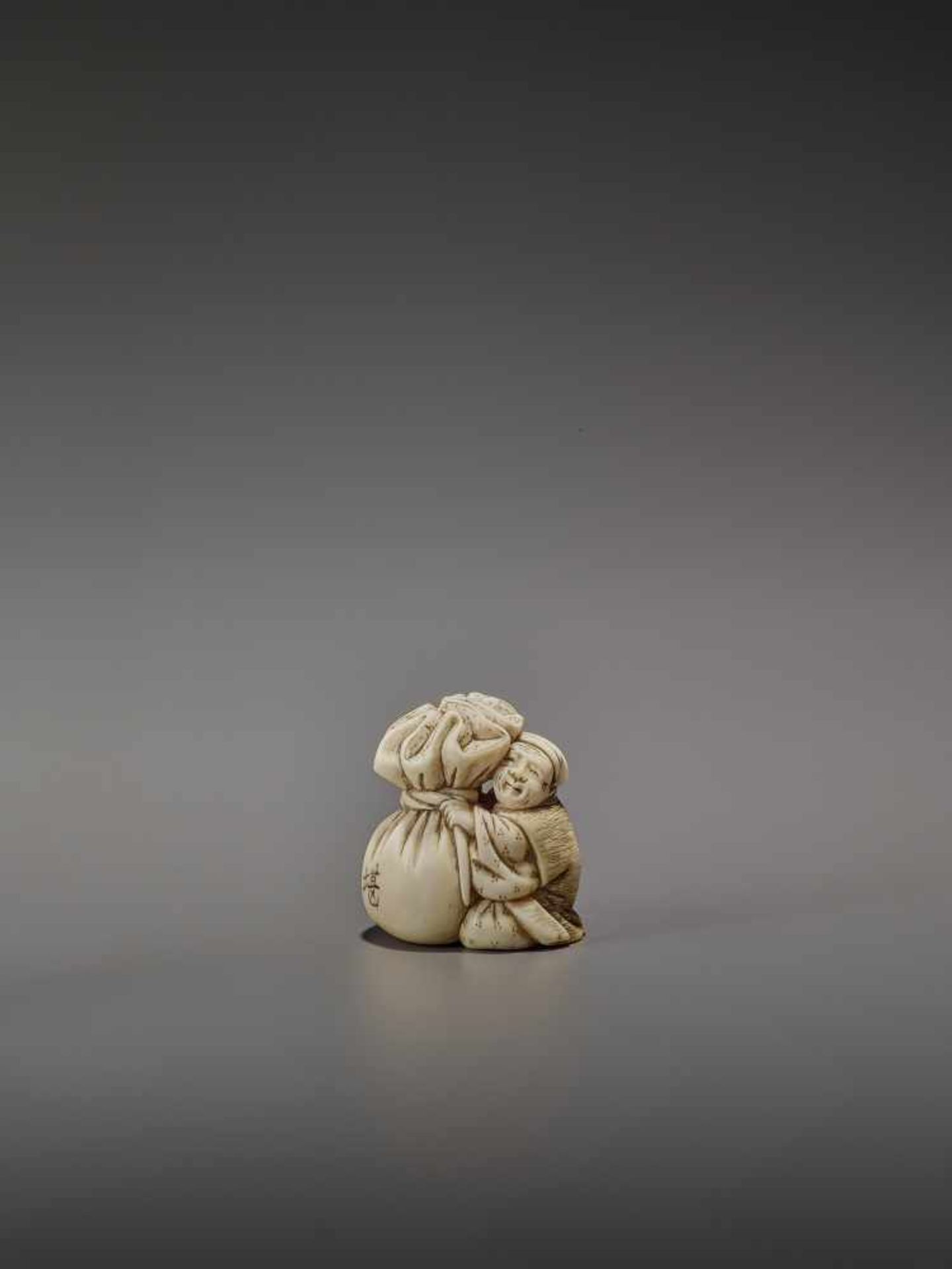 OKURA: A RARE IVORY NETSUKE OF KANNINBUKURO By Ogura Tomoyuki, signed OkuraJapan, Edo, mid-19th