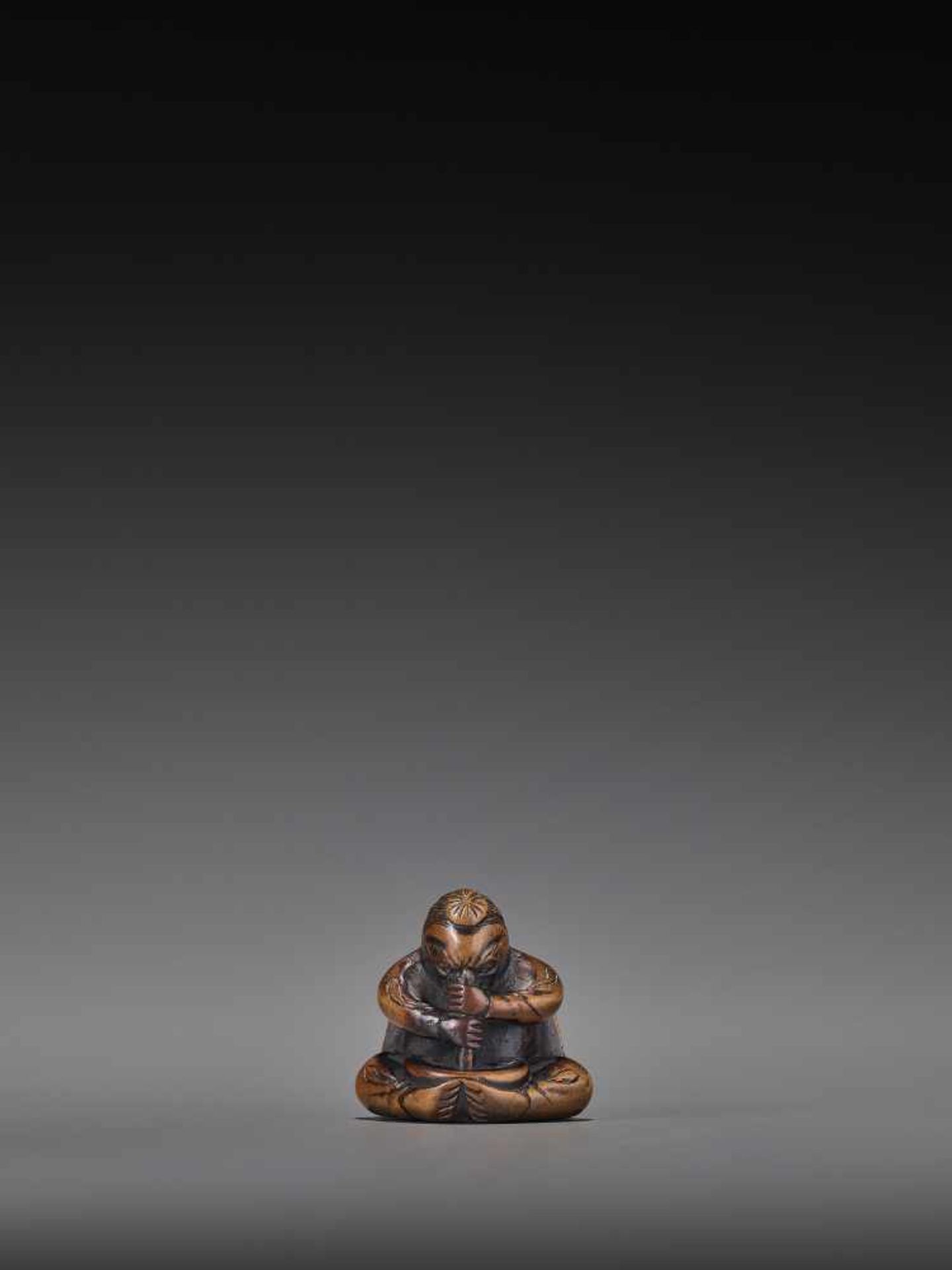 A WOOD NETSUKE OF A TENGU STIRRING MISO UnsignedJapan, 19th century, Edo period (1615-1868)A wood