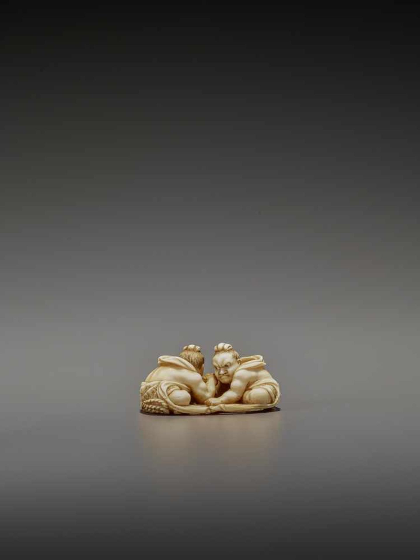 TOMOTAKA: AN IVORY NETSUKE OF TWO ARMWRESTLING NIO ON A WARAJI By Tomotaka, signed TomotakaJapan, - Image 5 of 11