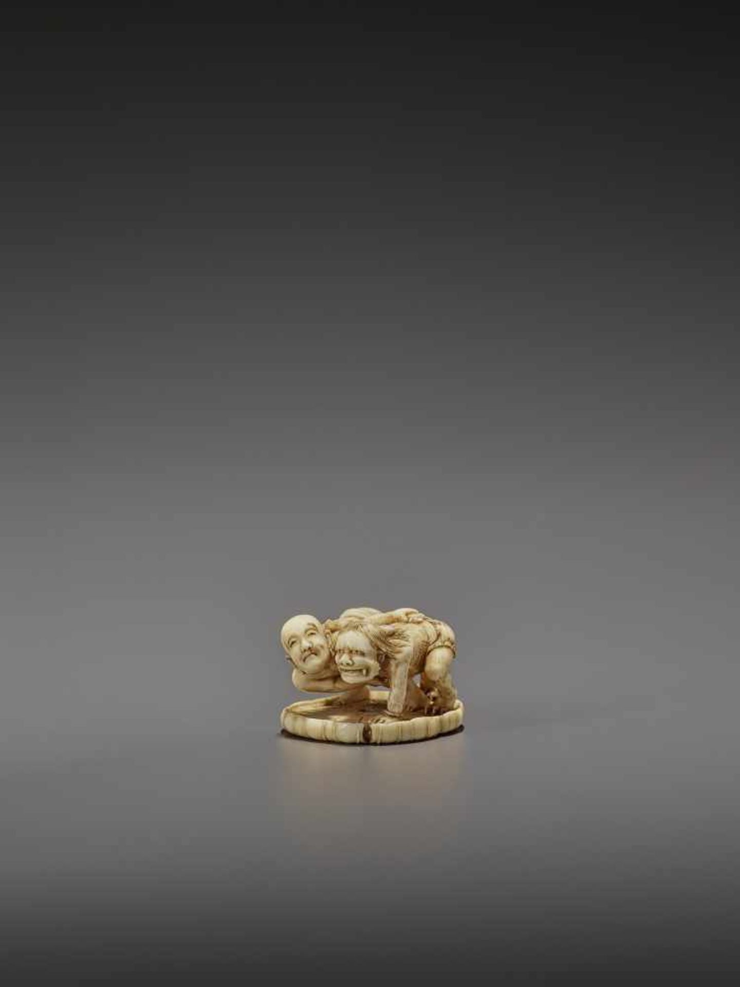 HO RAKUMIN: A FINE IVORY NETSUKE OF JIZO WRESTLING AN ONI By Ho Rakumin, signed Ho Rakumin with