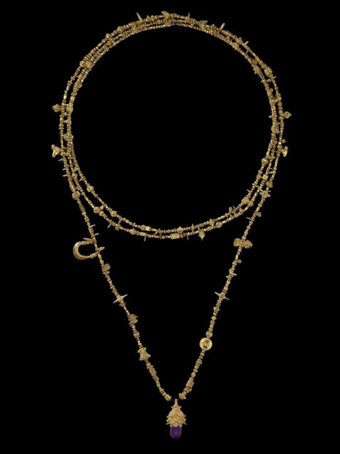 A LONG INDIAN GOLD NECKLACE WITH A LOTUS PENDANT AND AMETHYST India, 19th century. A superb necklace