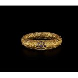 A CHAM REPOUSSÉ GOLD BRACELET WITH A GEMSTONE FLOWER AND ELEPHANTS Champa, classical period,