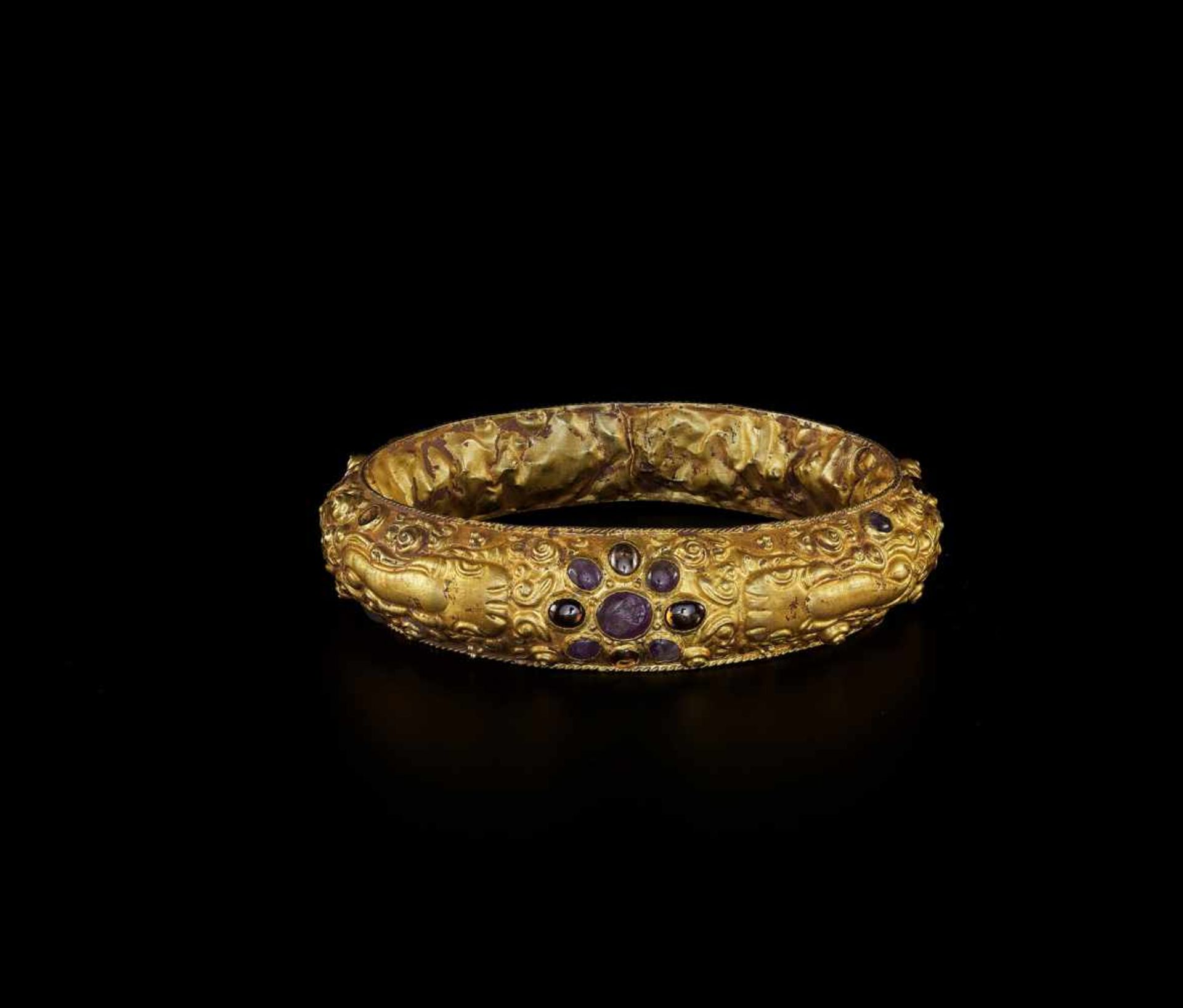 A CHAM REPOUSSÉ GOLD BRACELET WITH A GEMSTONE FLOWER AND ELEPHANTS Champa, classical period,