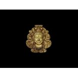 A CHAM GOLD REPOUSSÉ PENDANT DEPICTING SHIVA WITH GEMSTONES Champa, classical period, 10th