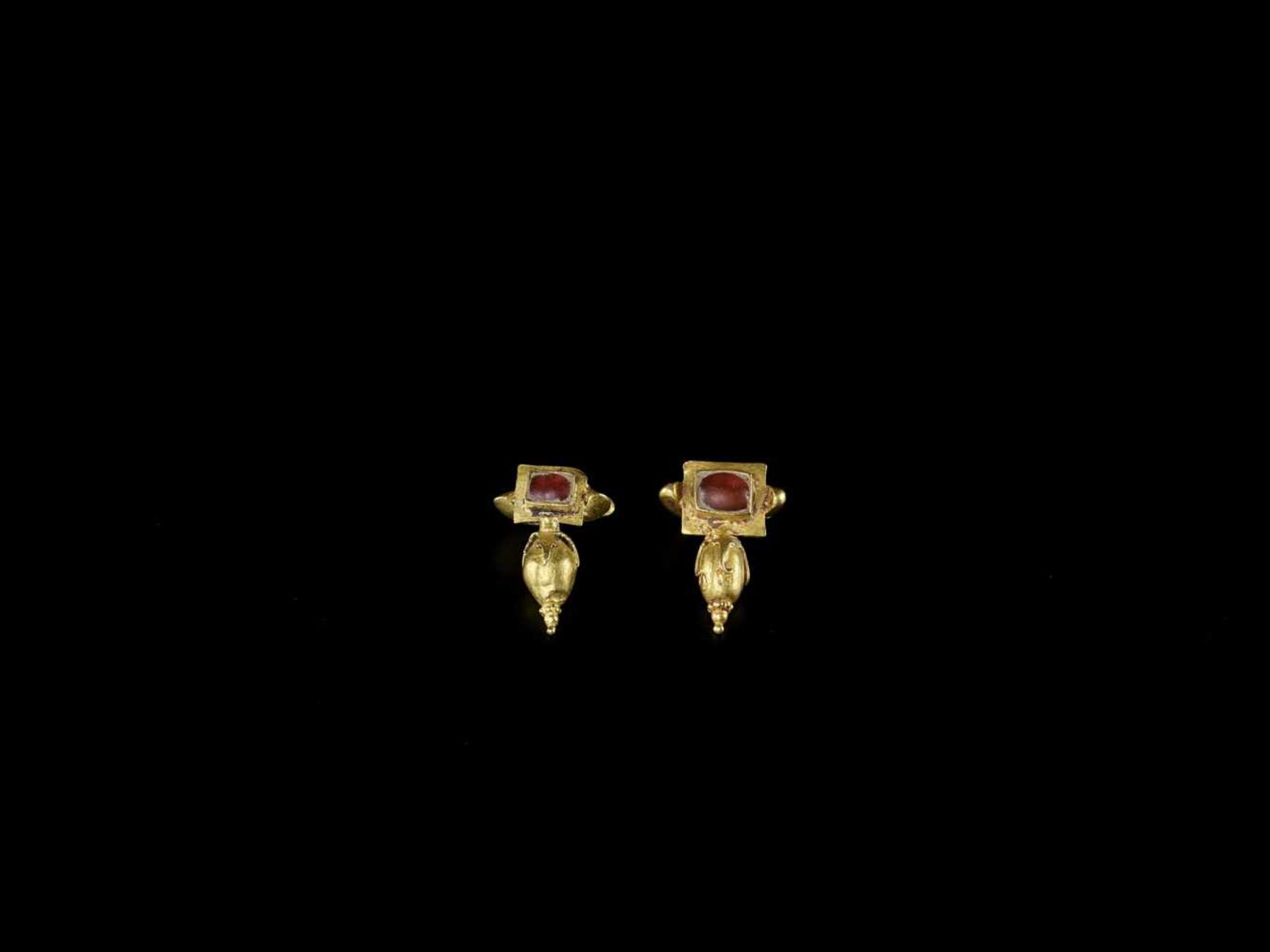 A PAIR OF CHAM GOLD EAR ORNAMENTS WITH RED GEMSTONES Champa, 12th – 14th century. Each earring is