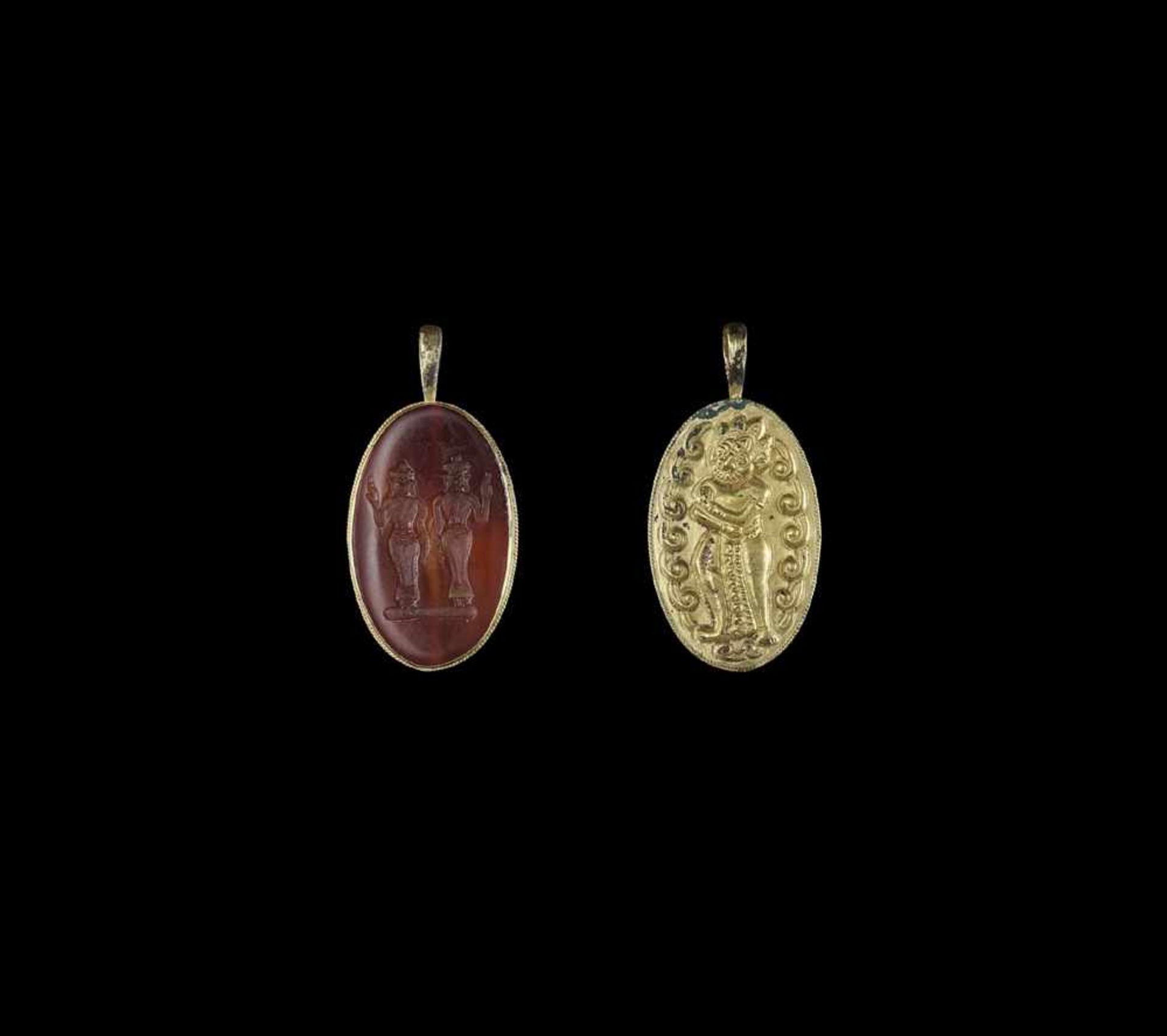 A CHAM REPOUSSÉ GOLD PENDANT WITH STONE INTAGLIO DEPICTING TWO HINDU DEITIES Champa, classical