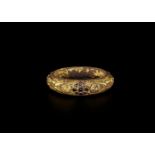 A CHAM REPOUSSÉ GOLD BRACELET WITH A GEMSTONE FLOWER AND GUARDIAN LIONS Champa, classical period,