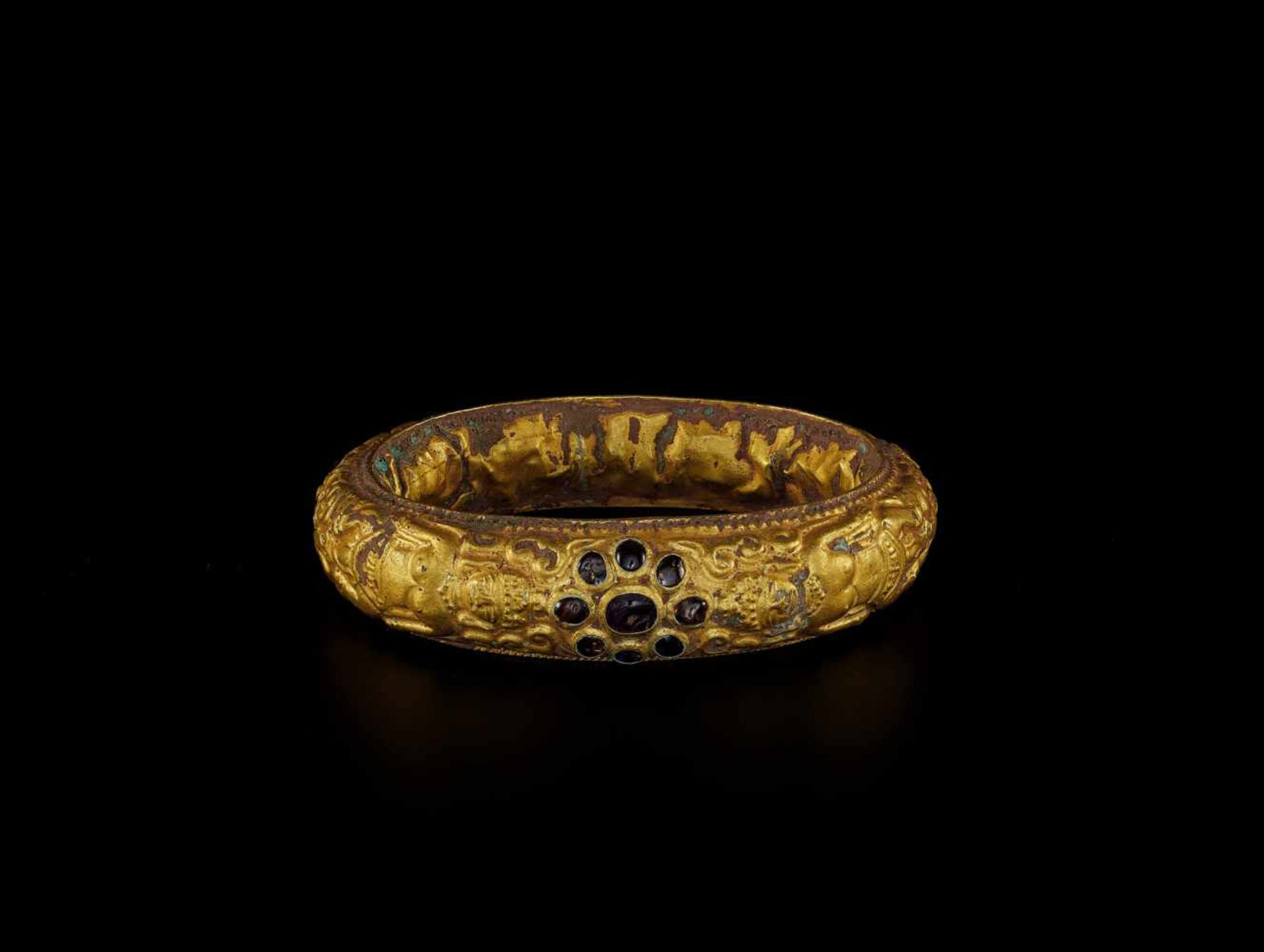 A CHAM REPOUSSÉ GOLD BRACELET WITH GEMSTONE FLOWERS AND HINDU GODDESSES Champa, classical period,