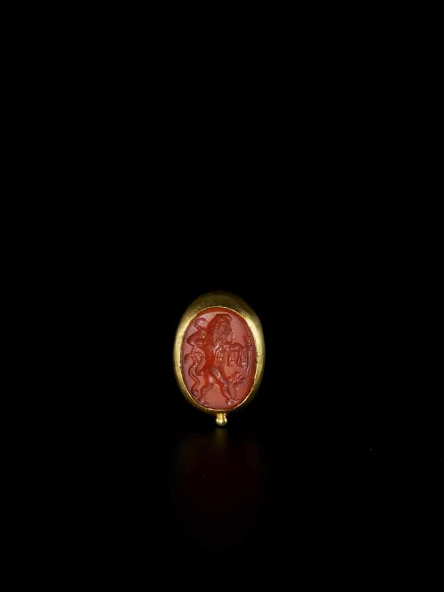 A MASSIVE CHAM GOLD RING WITH A LARGE RED CARNELIAN INTAGLIO Champa, c. 9th – 10th century. The