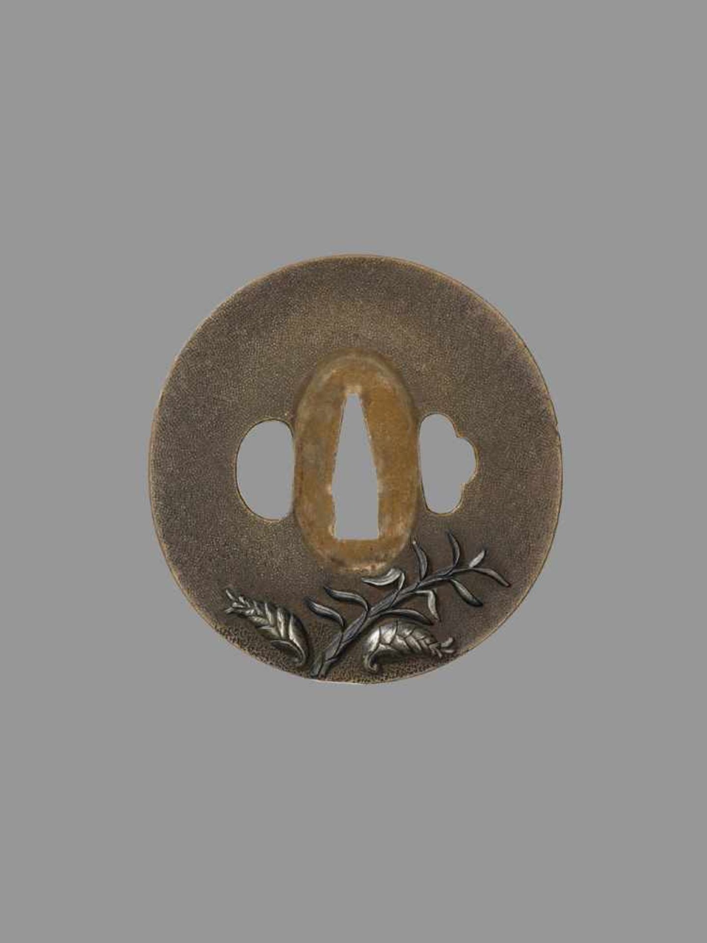 A RARE SHOAMI SCHOOL TSUBA Japan, 18th/19th century, Edo period (1615-1868)The copper marugata tsuba