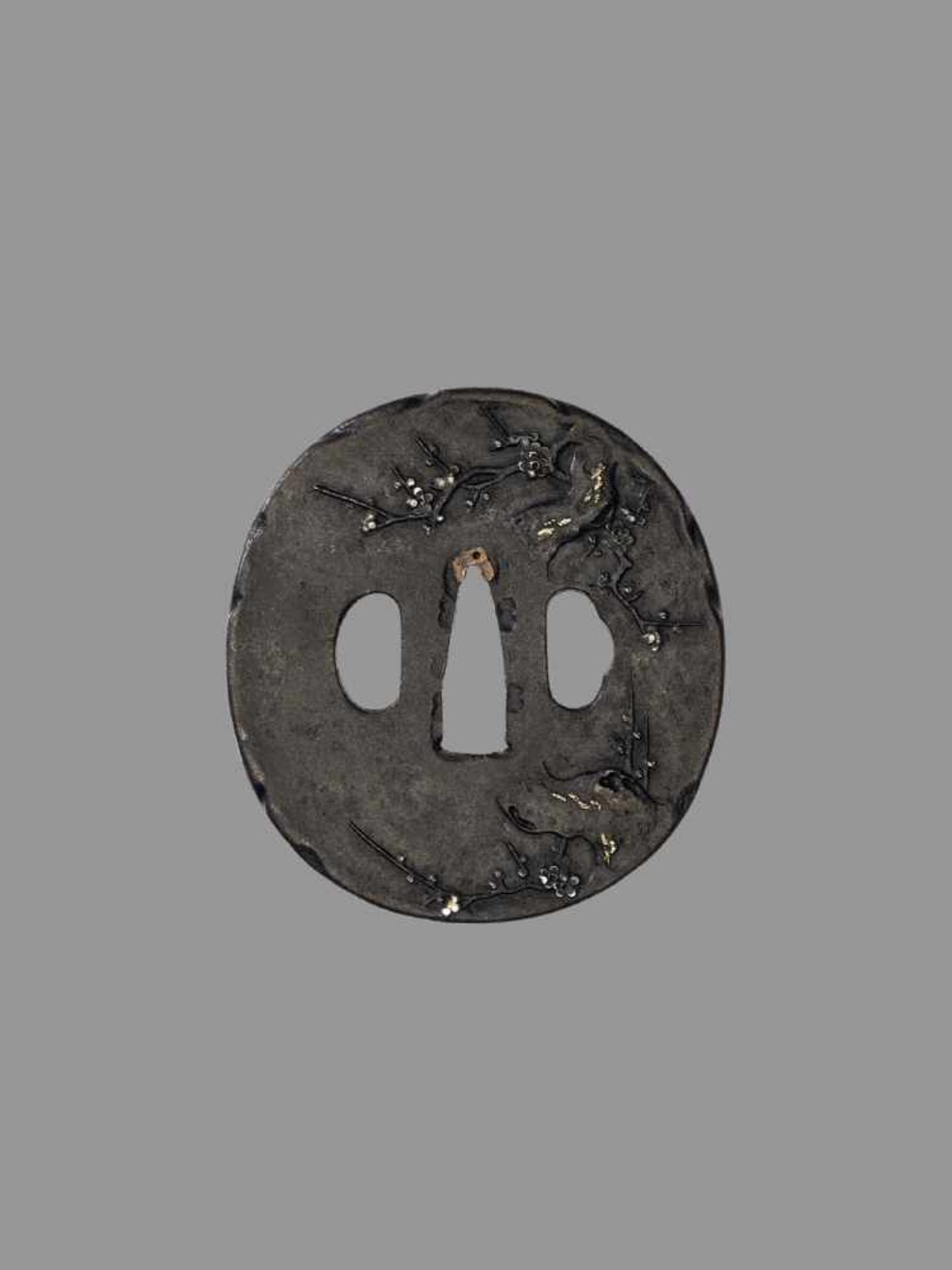 AN IRON TSUBA WITH CHERRY BLOSSOMS Japan, 17th century, Edo period (1615-1868)An iron tsuba of