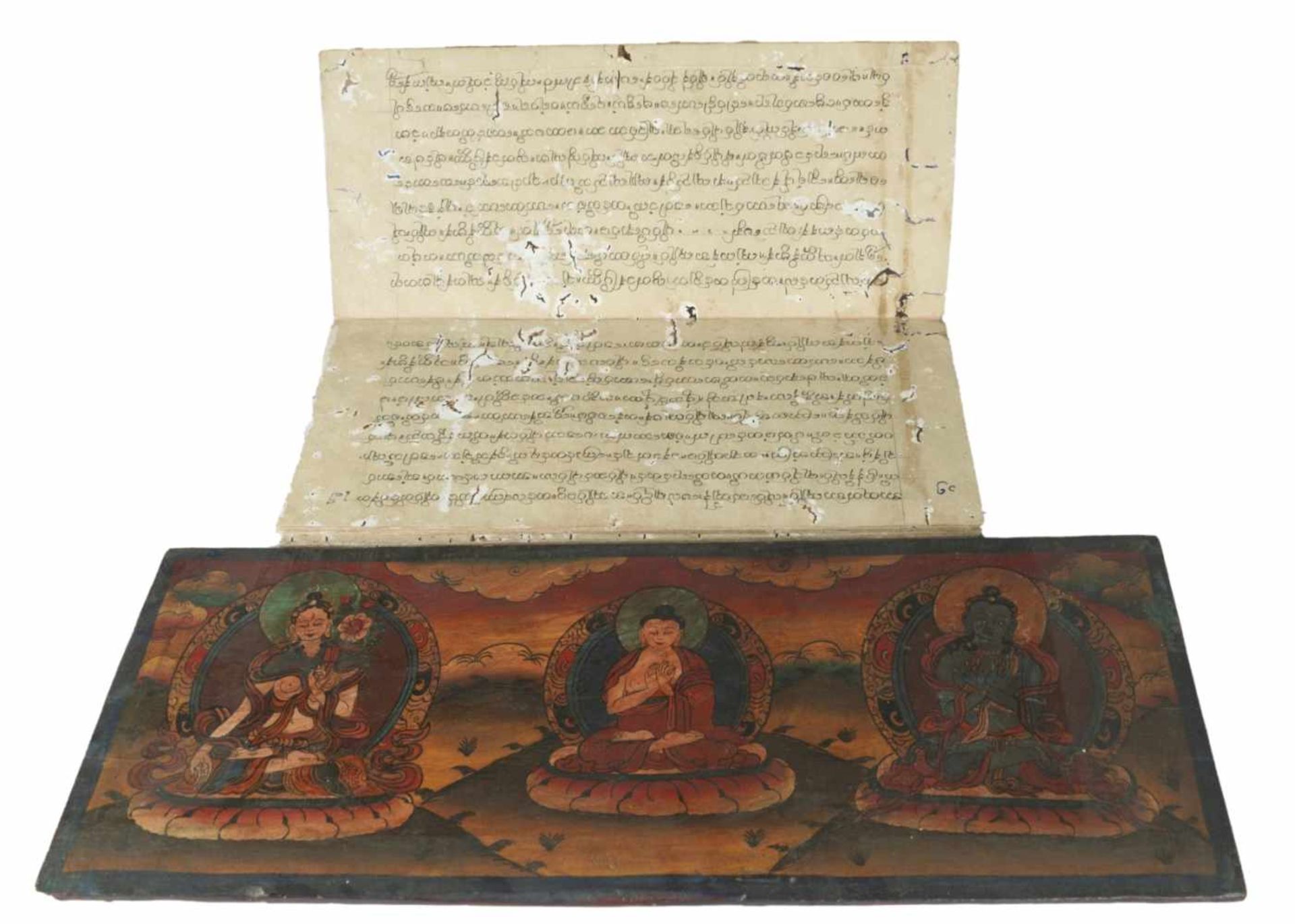 A Buddhist manuscript between two elaborately designed book covers made of wood and with