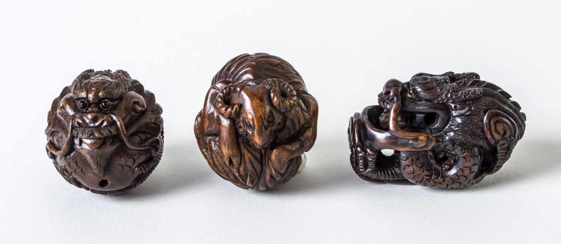 Three netsuke of a sheep and two dragons, Japan, woodcarving, signed, probably around1900, height: