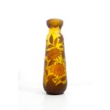 Gallè glass vase, XX Century, France. A glass vase with brown flowers decoration on yellow base. H