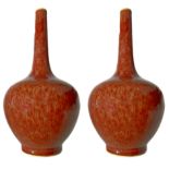 Pair of bottle vases with uniform red streaks of light base over the entire surface. Mark