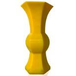 Small thin glass jar hexahedral shape and baluster, uniform yellow color on the whole surface.