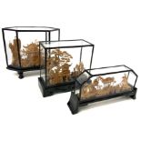 Display case set with wooden and glass structures containing cork sculptures depicting pagodas.