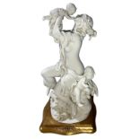 Statuette in white porcelain, gold base color. Maternity. H Cm Cm 25. Base 12,5x12,5. Dated 1987.