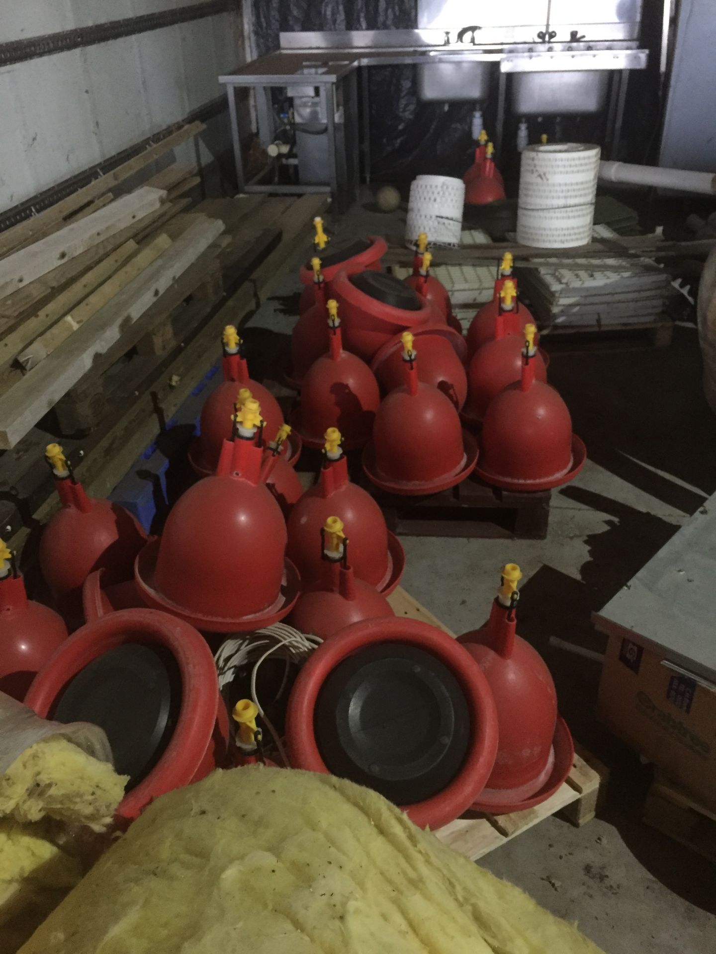 Approx. 70 red plastic bell water feeders with associated blue plastic pipework, (10) galvanised