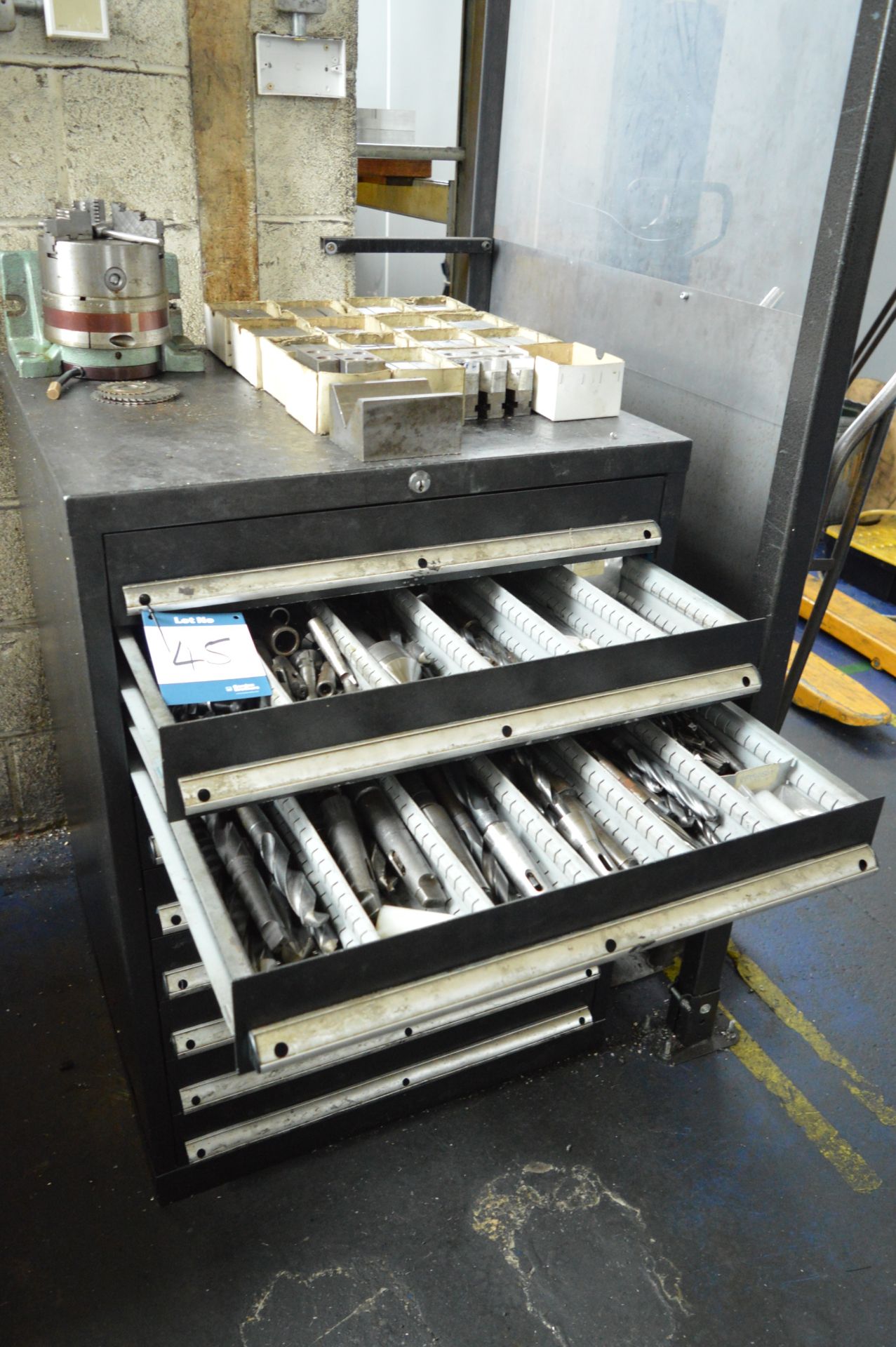 Tool cabinet and contents to include: jaws, drills, reamers etc., as lotted