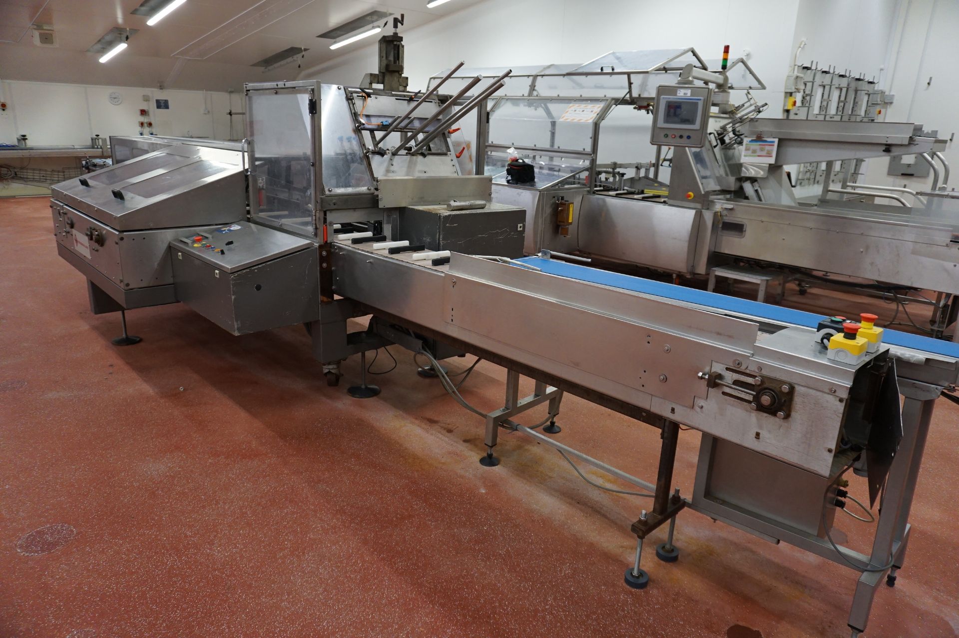 Bradman Lake Packaging Station Comprising: motorised infeed centering conveyor; SL90 cartoning