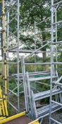 Aluminium scaffold tower comprising; 10 end frames 10 cross beams 4 wheeled feet 2 staging boards