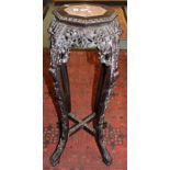 A Japanese dark hardwood carved plant stand having marble insert