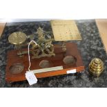 Set of early 20th Century brass postage scales with weights open mahogany base,