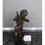 A 19th century Grand Tour bronze figure of a seated putti, playing the triangle, 20 cm high.