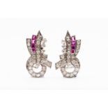 A pair of Art Deco diamond and ruby set clips, the stylised ribbon bow design,