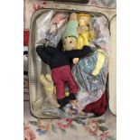 A suitcase containing a collection of dolls etc.