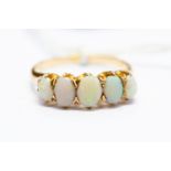 An early 20th Century 14 k gold ring set with five oval opals, size M, total gross weight approx 2.