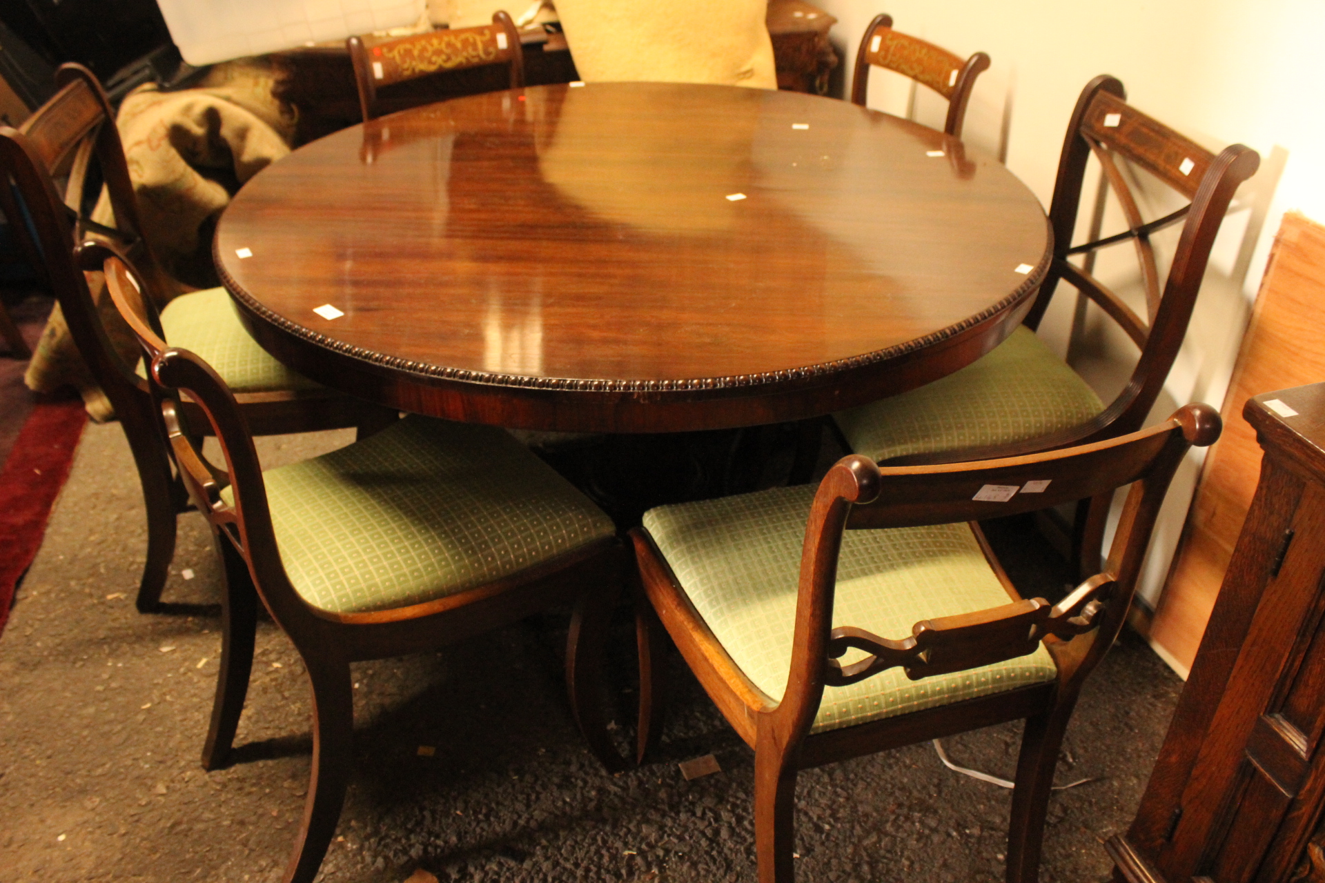 An early Victorian rosewood tilt top pedestal breakfast table, standing on a triform base,