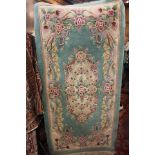 Small green rug with floral pattern