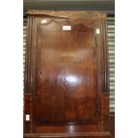 A George III oak and mahogany hanging corner cupboard,