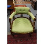 An Edwardian mahogany tub chair, with green upholstered back, spindle gallery to back,