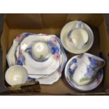 An Art Deco Floral pattern part tea set with white ground. One box.